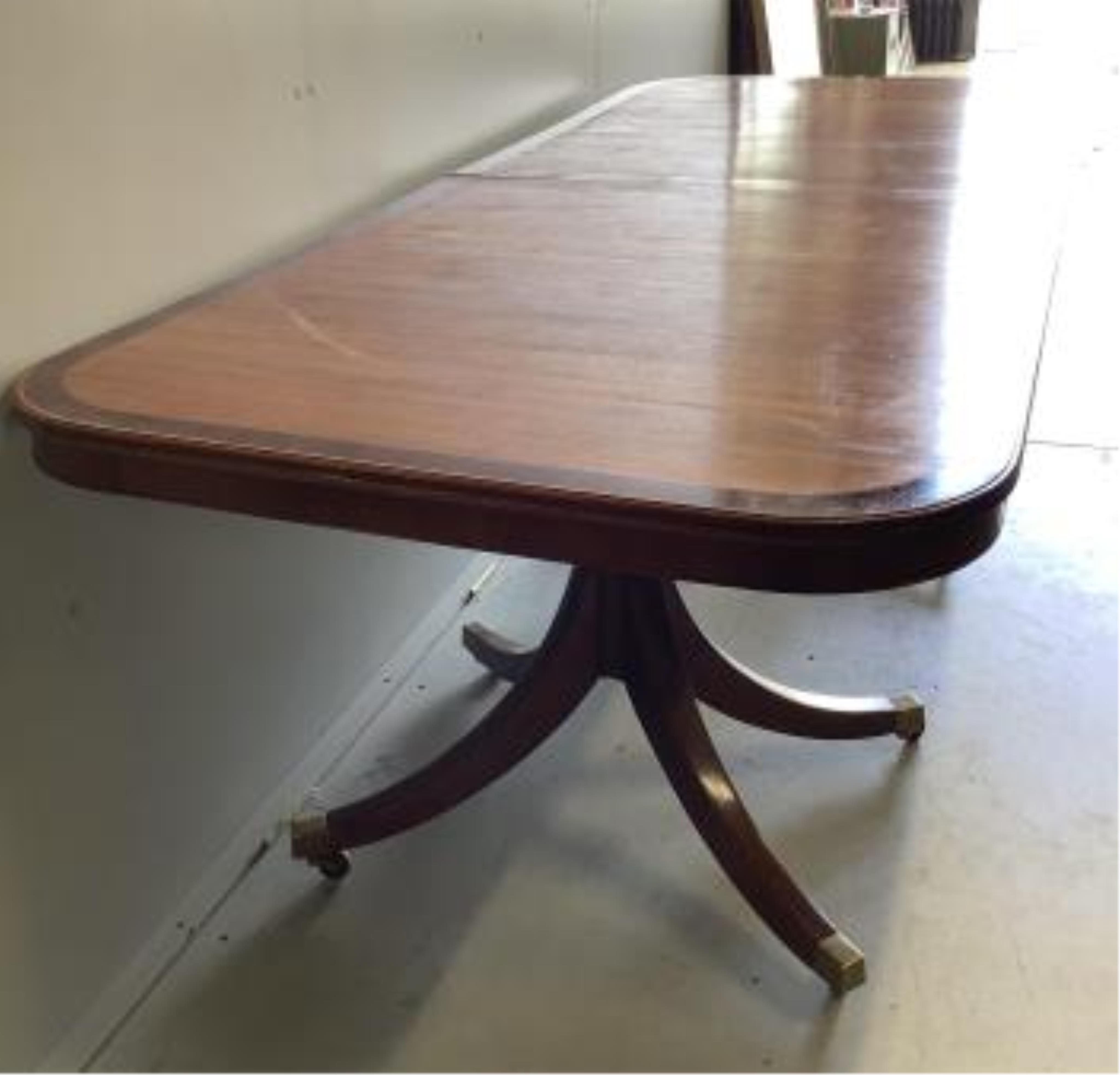 A reproduction mahogany twin pillar extending dining table, extended 300cm, two spare leaves, depth 91cm, height 72cm. Condition - good